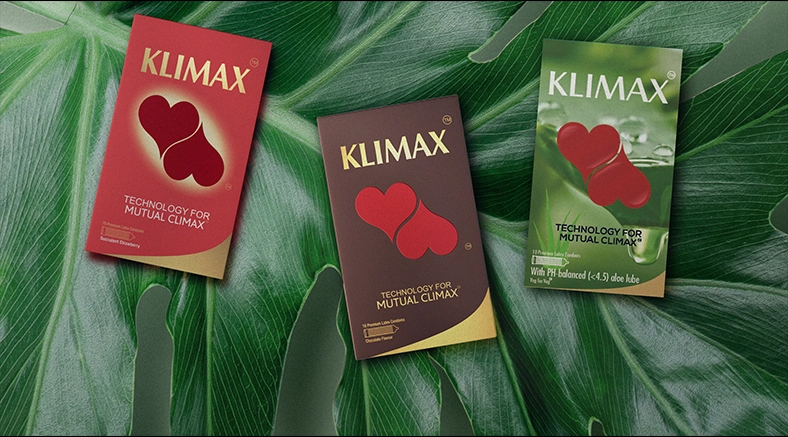 Klimax condom packs arranged on green leaves, highlighting technology for Mutual Climax